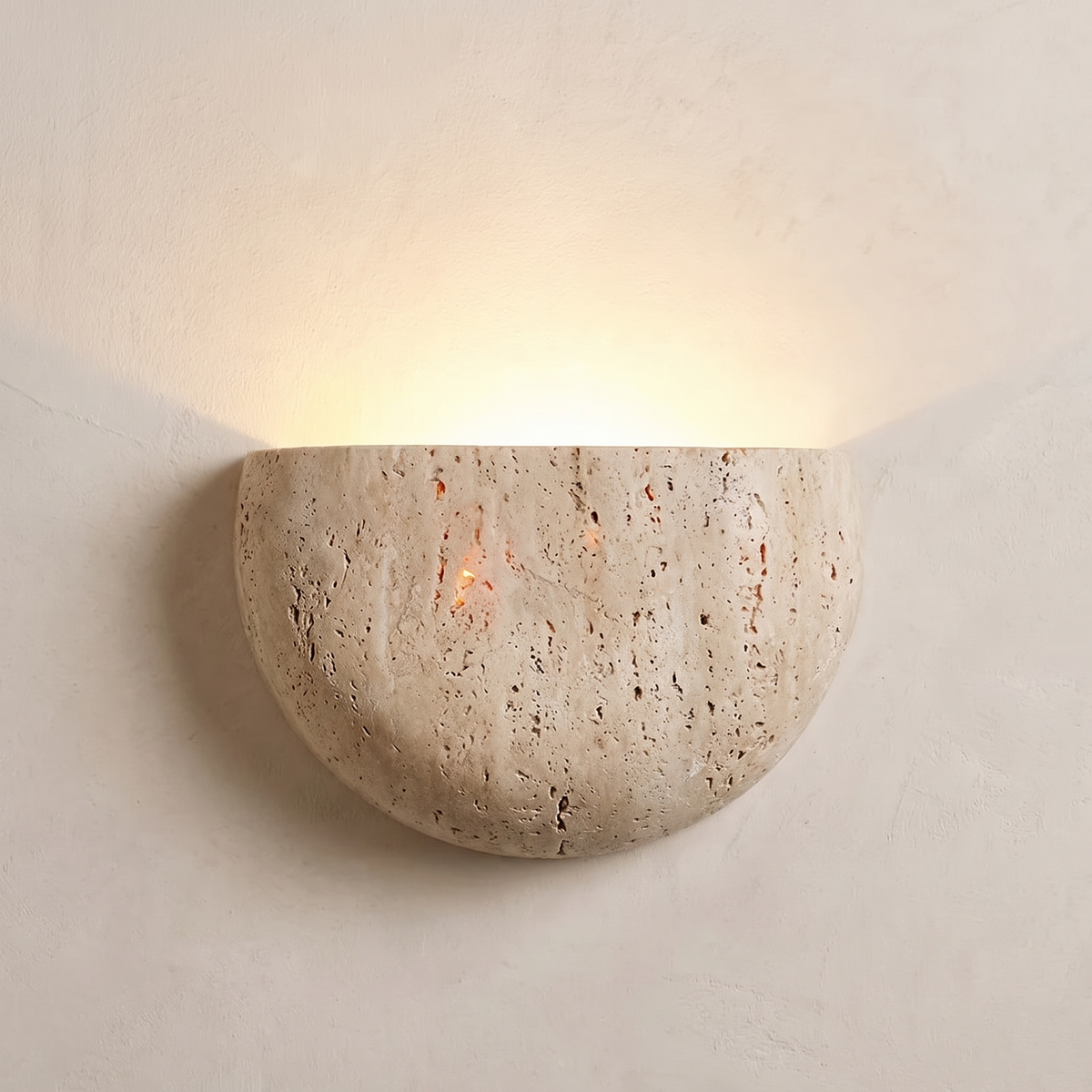 Capri half moon wall light in natural stone, open side up, washing warm light up a limewash wall