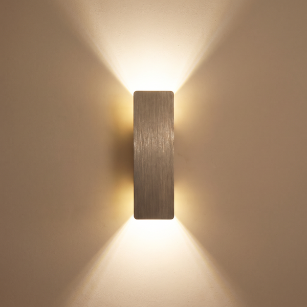 Munich LED wall light casting light up and down a plaster wall