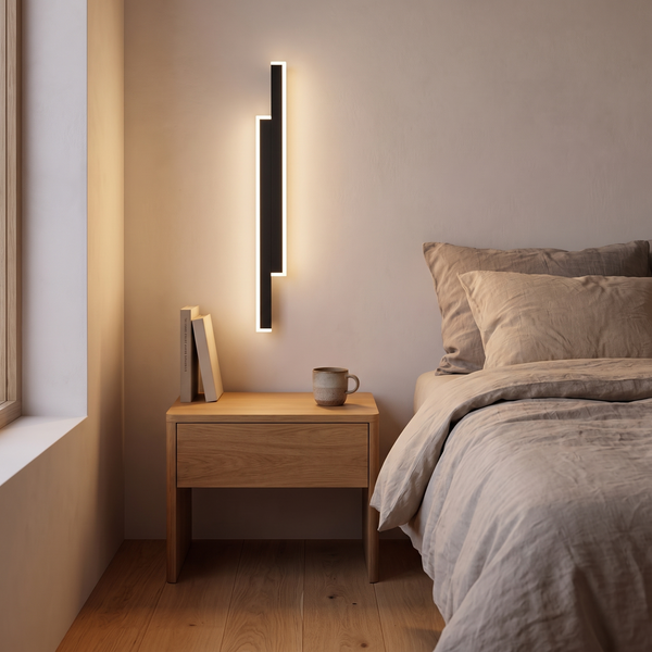 Stockholm wall light mounted upright beside a bed, its 40 cm length sitting just above an oak bedside table